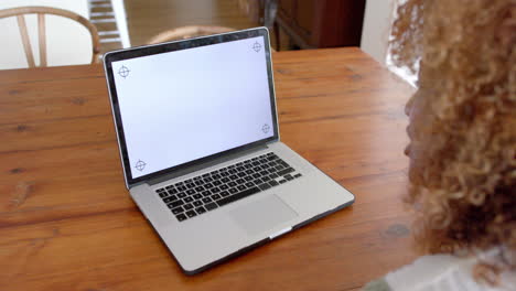 African-american-woman-using-laptop-with-copy-space-on-screen,-slow-motion