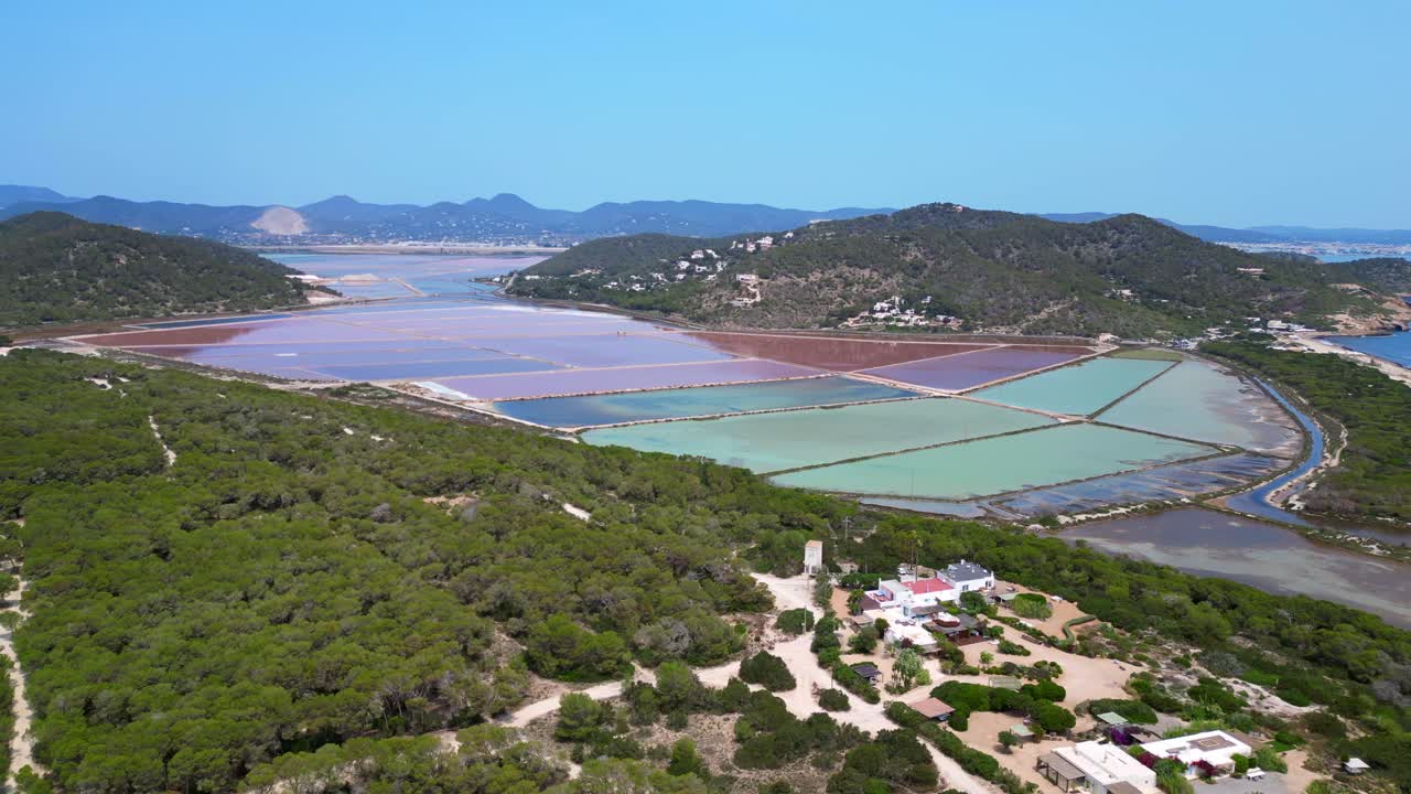 colorful salt flats of Ibiza with the Mediterranean vegetation in the foreground. Lovely aerial view flight static tripod hovering drone