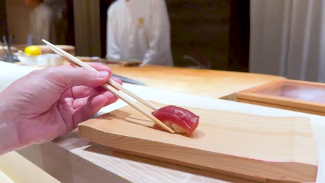 chef prepares sushi for a customer