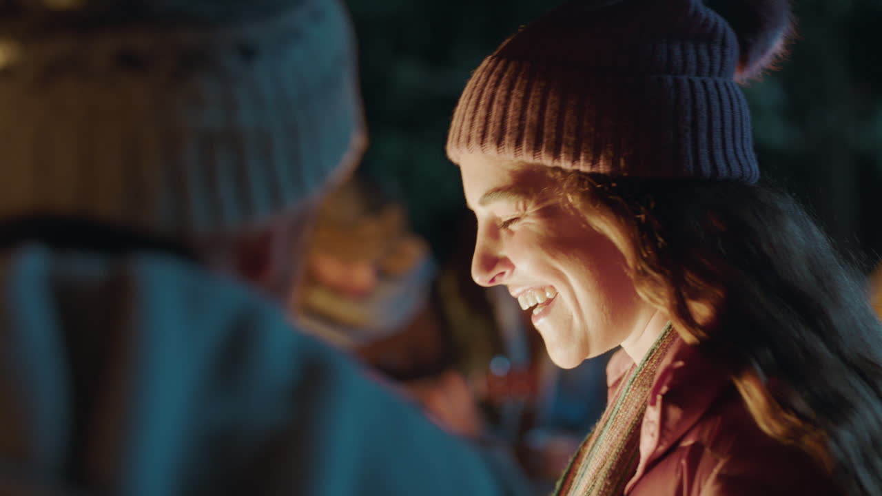 friends camping happy woman chatting to man flirting having conversation smiling enjoying romantic connection by campfire 4k