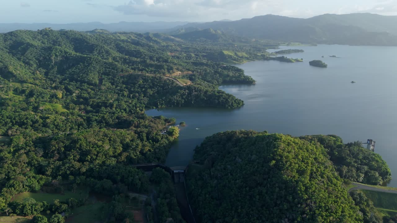 Hatillo Dam and vast reservoir, surrounded by lush green mountains and tranquil waters, ideal for environmental, tourism, and hydroelectric themes, Dominican Republic. Aerial drone