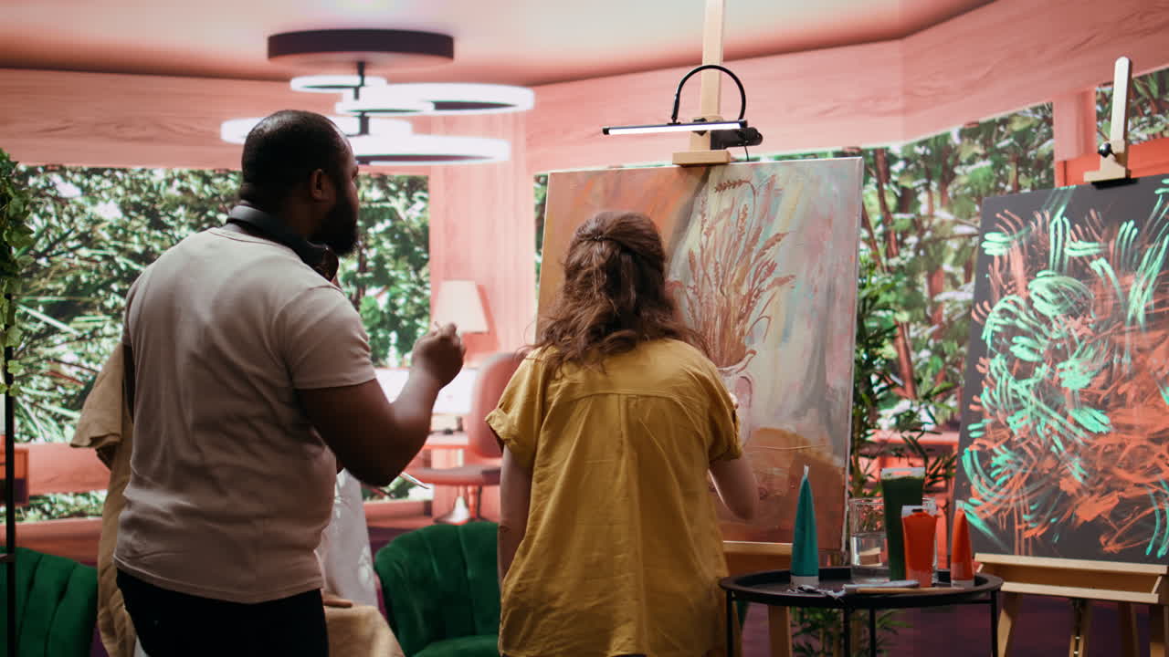 Artists collaborating on a painting in an art studio