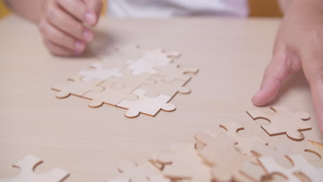 businesswoman hand connecting jigsaw puzzle with sunlight effect, business solutions, success, and strategy concept