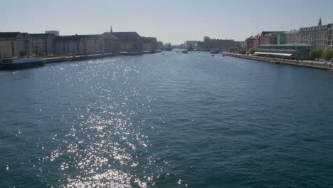 sparkling waters on copenhagen's broad canal under a clear sky