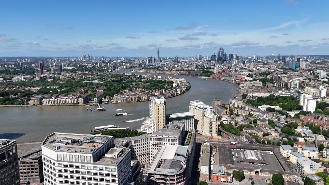 Drone flight over the Isle of Dogs revealing sweeping views of the City of London skyline and the River Thames capturing urban contrast and waterfront beauty from above.