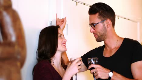 Couple-interacting-with-eachother-while-drinking-red-wine