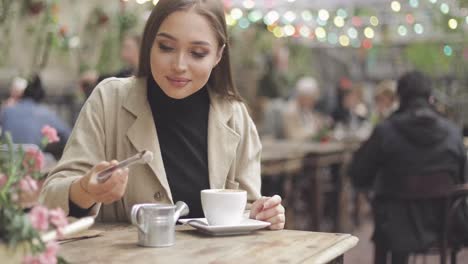 girl pouring sugar in coffee