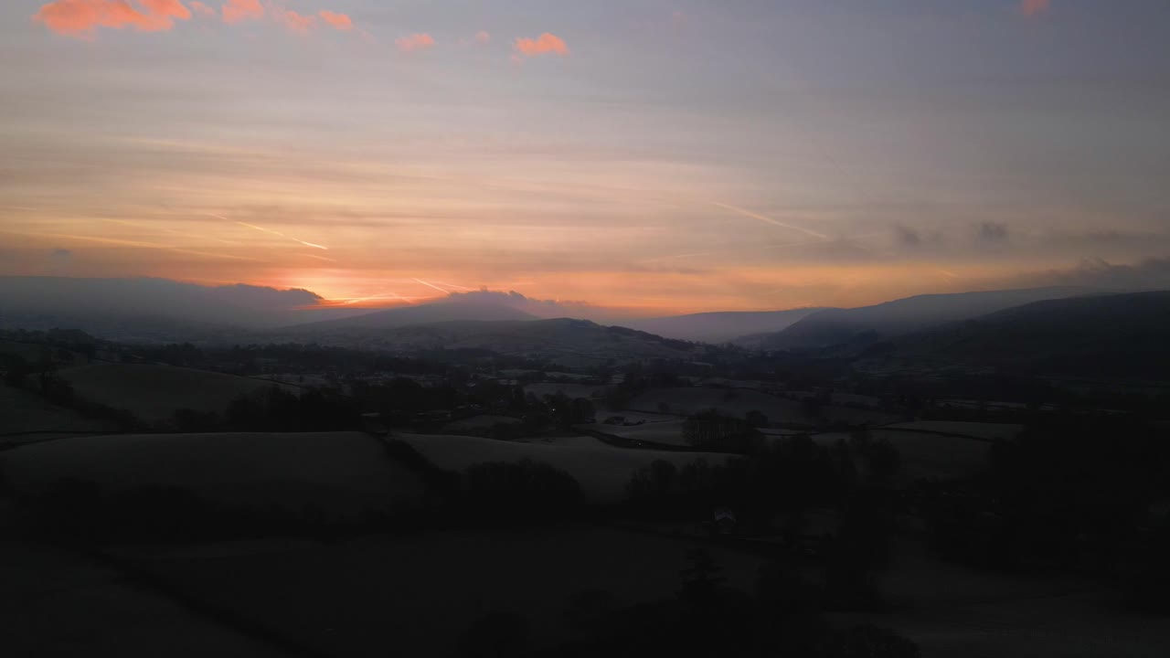 Stunning Drone footage of sunrise in the Yorkshire Dales above the village of Sedbergh. Dawn sunrise above the hills and misty landscape of the Yorkshire dales national Park.
