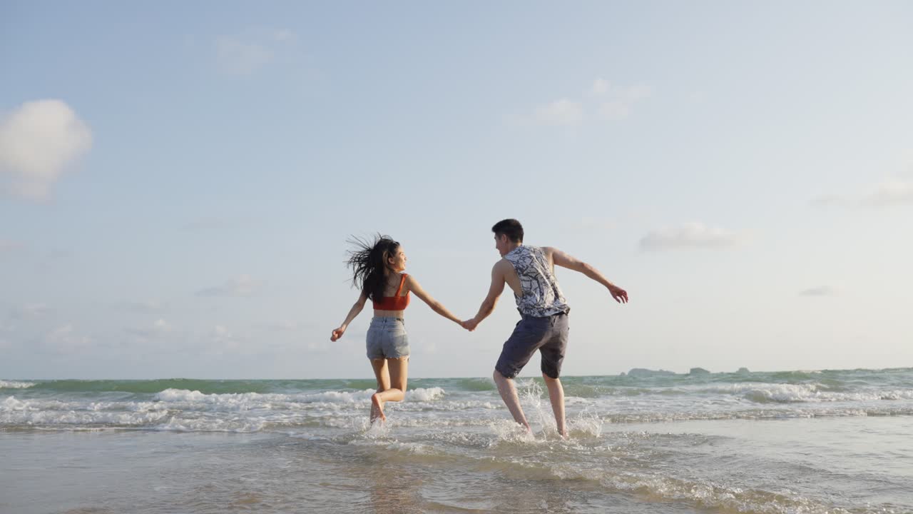 Couple playing in the ocean waves