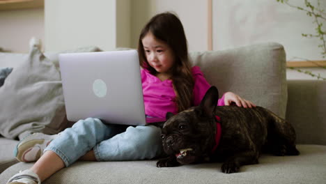 girl petting dog at home