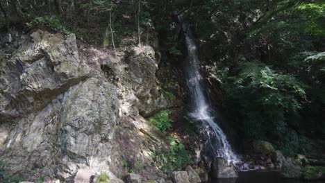 small waterfall flowing from mt kinka, gifu koen japan