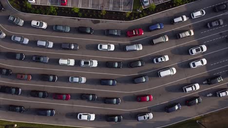 cars and vehicles slowly moving in gas station line up to pump fuel during pandemic shortage