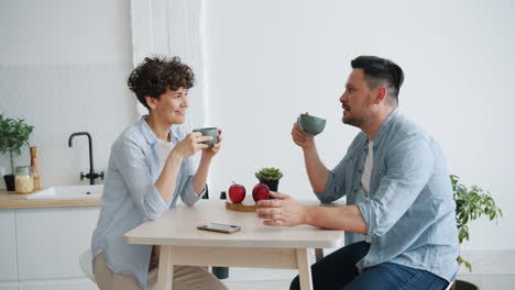 couple enjoying coffee in modern kitchen