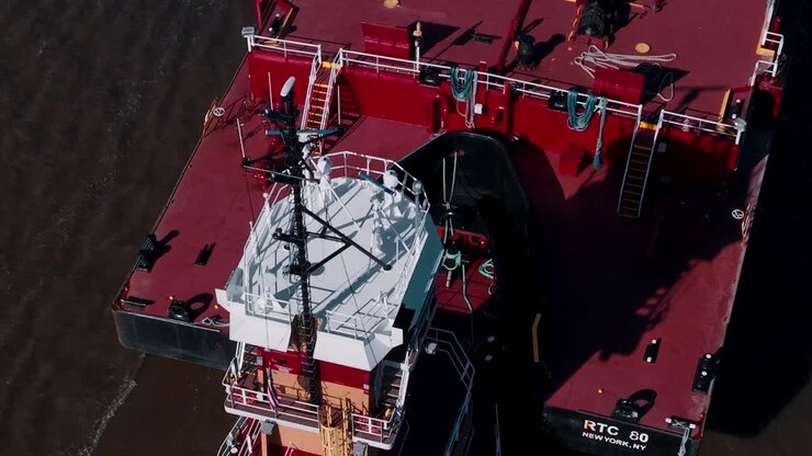 Tugboat operates in New York waters, assisting large vessels during the day