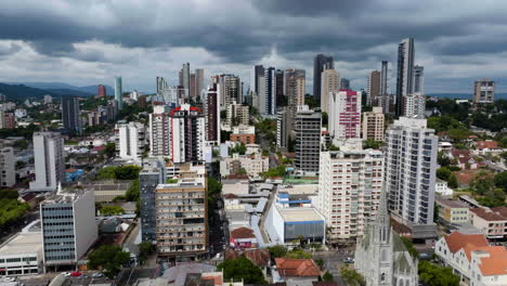 Aerial-view-over-colorful-condos,-dramatic-clouds-in-sunny-Porto-Alegre,-Brazil