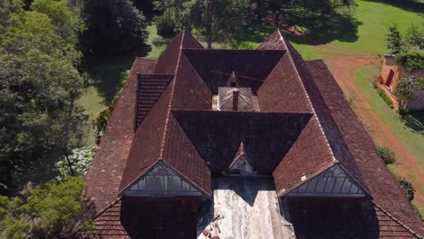 drone fly-in top-down of old building with red tiles in santa inés