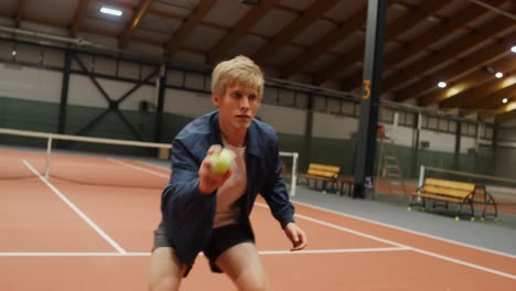 man playing indoor tennis