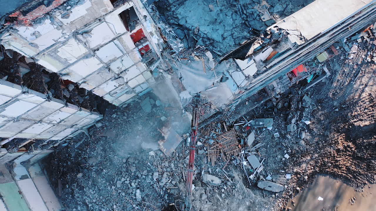 Destructive demolition building by excavator. Construction of destroyed house.