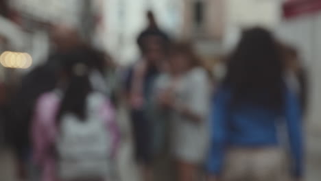 blurry crowd of people walking on a busy city street