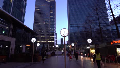 POV walking through Reuters Plaza at night in Canary Wharf.