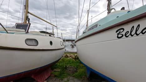 person walks through boats at dysart harbour