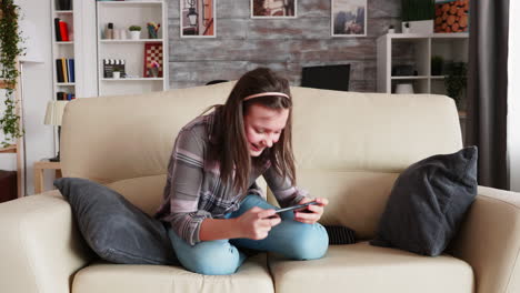 cheerful little girl playing video games