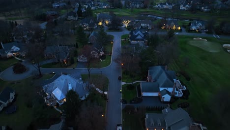 twilight over a quiet residential neighborhood with streetlights aglow