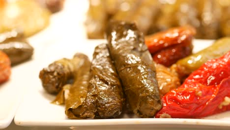 plate of stuffed grape leaves and peppers