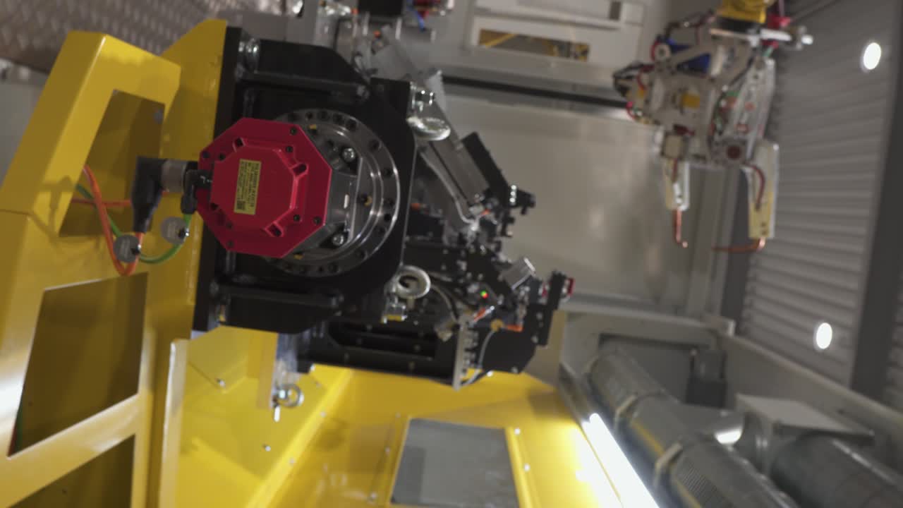 Roll shot over the part fixtures in the industrial robot machine, bright surroundings, 30fps, 4k