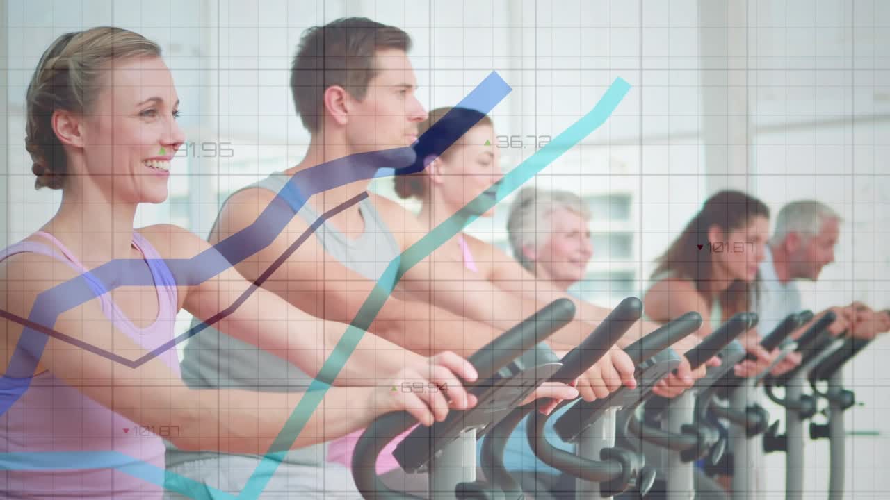 Camera tracking row, lead rider pedaling in spin studio, graphs overlaying riders tracking progress