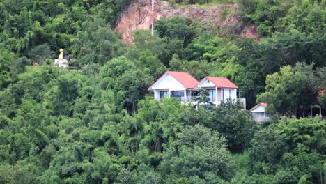 kaeng krachan with a small house and temple on the hillside with a slow zoom in thailand