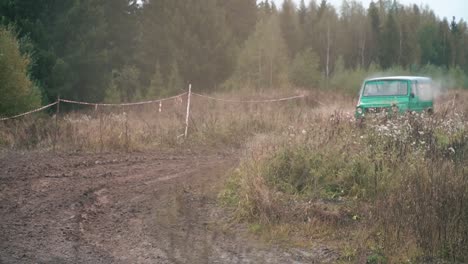 off-road vehicle driving through a muddy trail in a forest