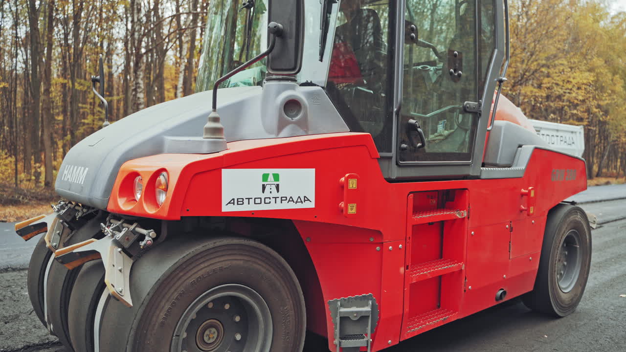 Construction site of road. Road construction works with roller compactor machine and asphalt finisher