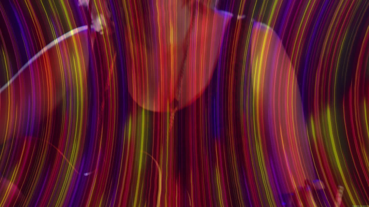 Designer analyzing neon light trails in design studio, highlighting flowing bokeh orbs