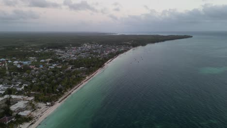Beach-resorts-and-homes-in-Uroa-Beach-Zanzibar-Island,-Tanzania-Africa,-Aerial-pan-right-shot