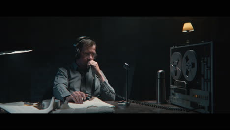 an intelligence officer listens to the wiretap recordings