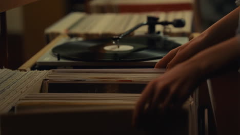 hands browsing vinyl records at a record store