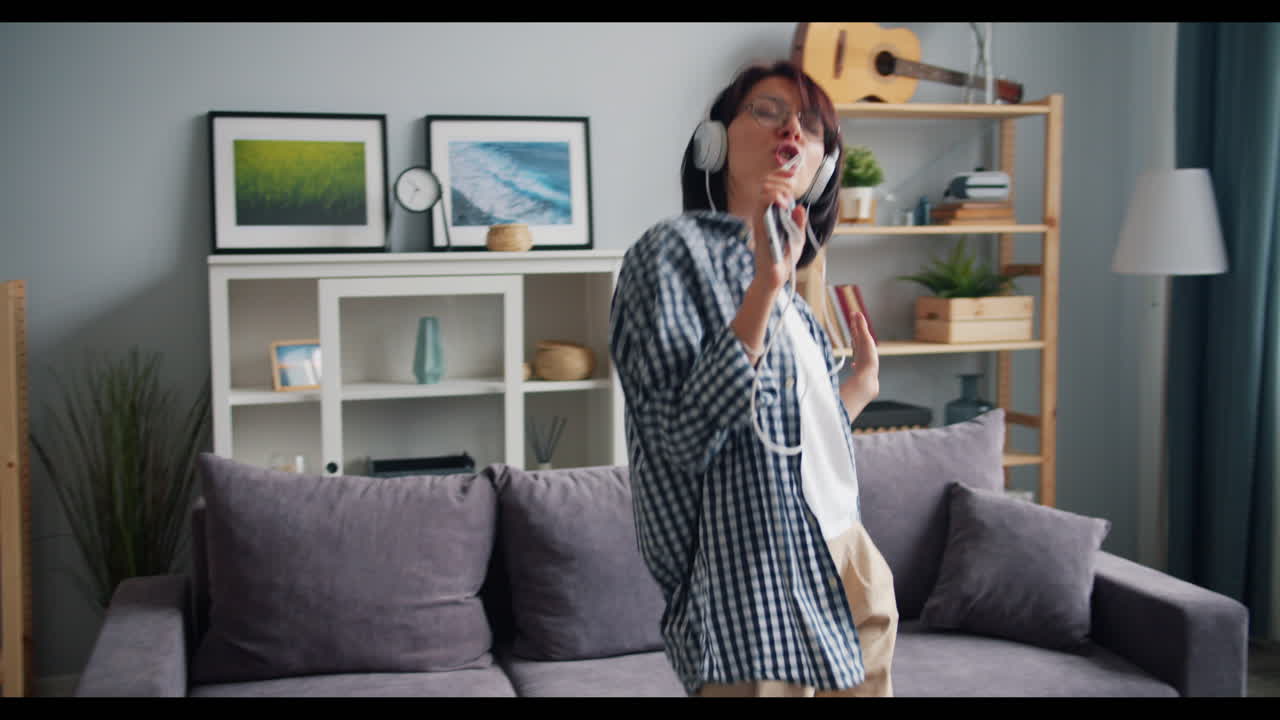 Woman Dancing and Singing in Living Room