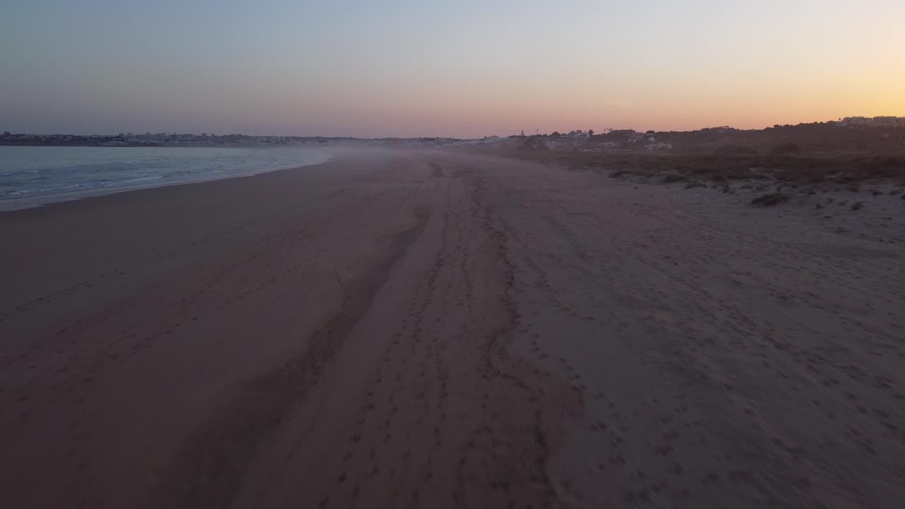 Sunset at Portugal Algarve, flying overt the beach, sea, waves and sand