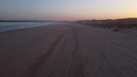 sunset at portugal algarve, flying overt the beach, sea, waves and sand