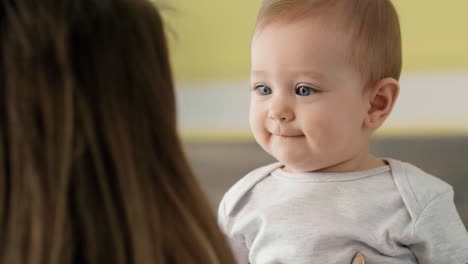 young mum playing with her baby