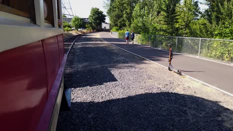 people walking along the train track trail