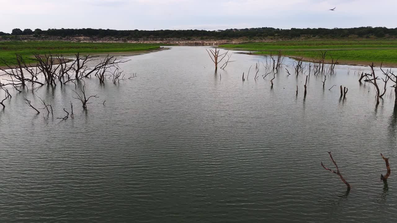 Low flying aerial shot gliding over the calm water of Canyon Lake in Texas