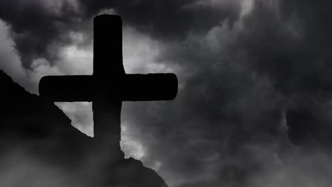 silhouette of stone cross against storm clouds background