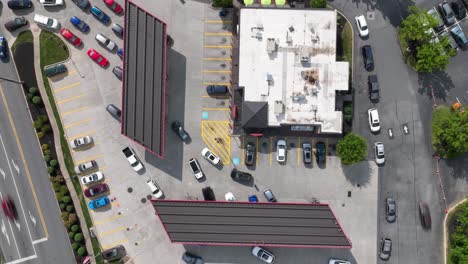 cars line up waiting to refuel at gas station during fuel shortage