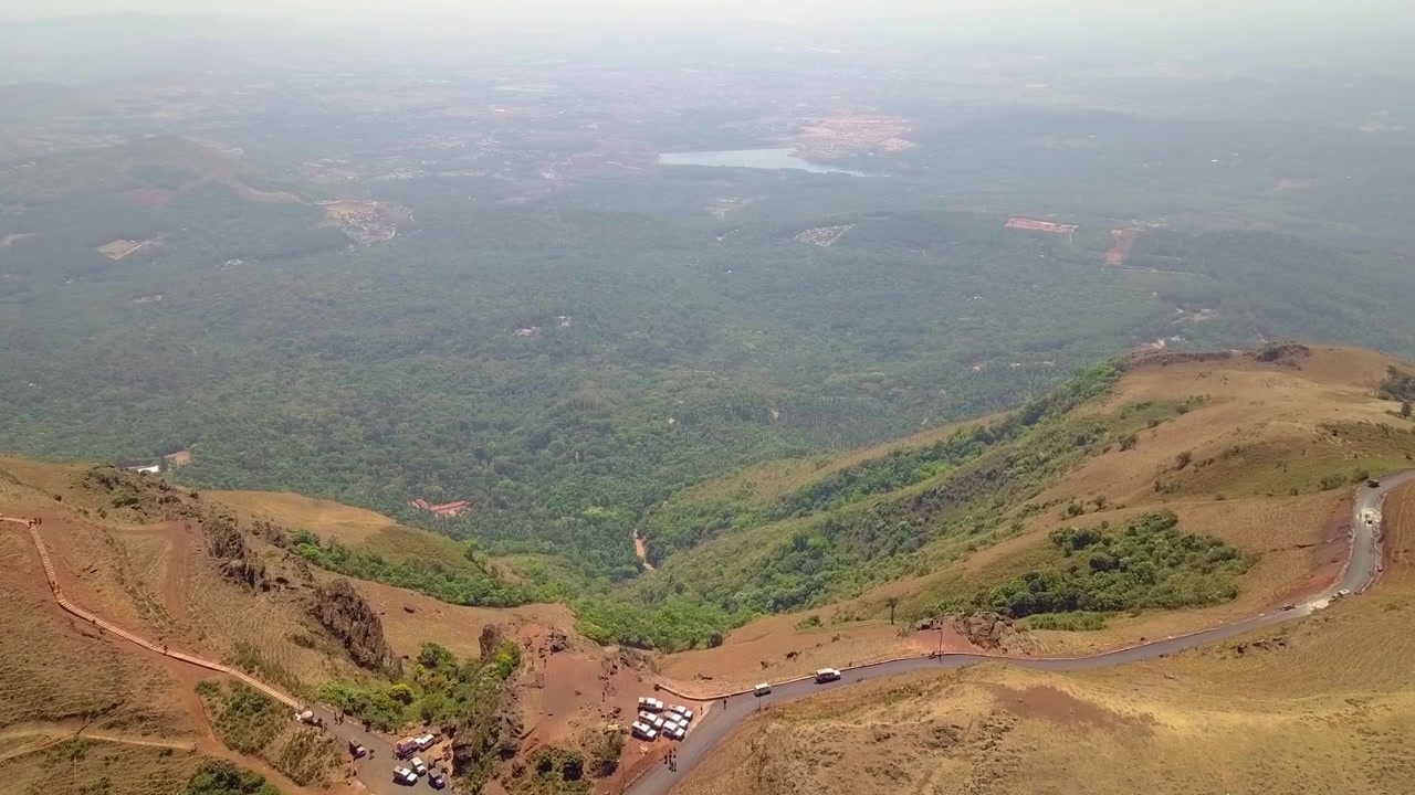Chikmagalur Hills scenic aerial view with winding roads, lush valleys, and distant lake