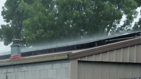 garage shed with solar panels in heavy rain storm bad weather, daytime, maffra, gippsland, victoria, australia