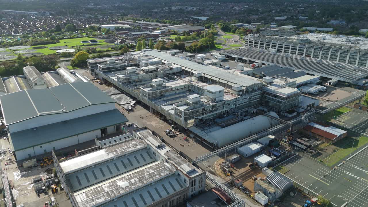 Slow aerial orbit of research complex abutting manufacturing works with container yards and logistic activity near Nottingham