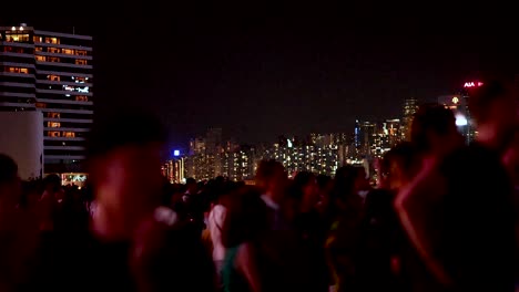 people gather for a nighttime light show