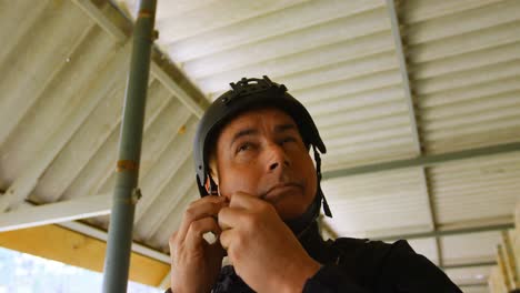 low angle view of mid-adult caucasian military soldier wearing combat helmet during military trainin